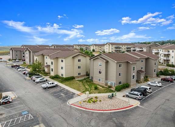 A parking lot in front of apartment buildings.