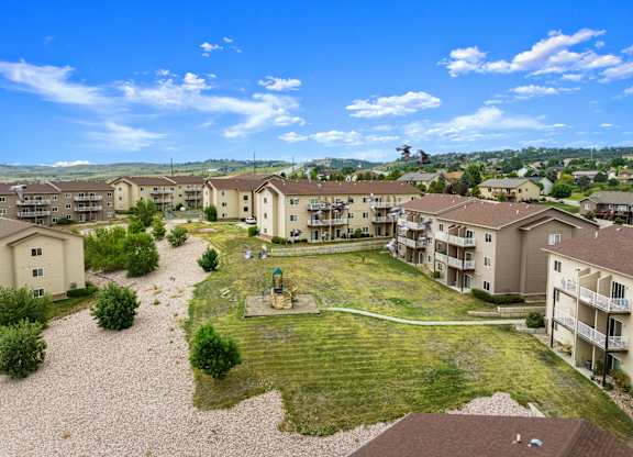 A sunny day at a residential complex with apartments and a playground.