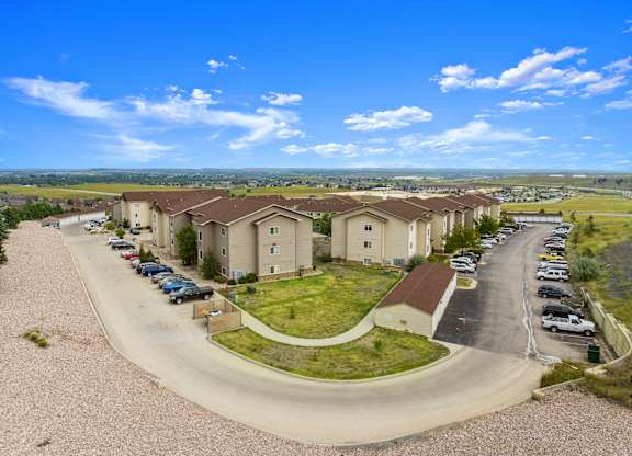 A residential area with houses and cars parked in the driveways.