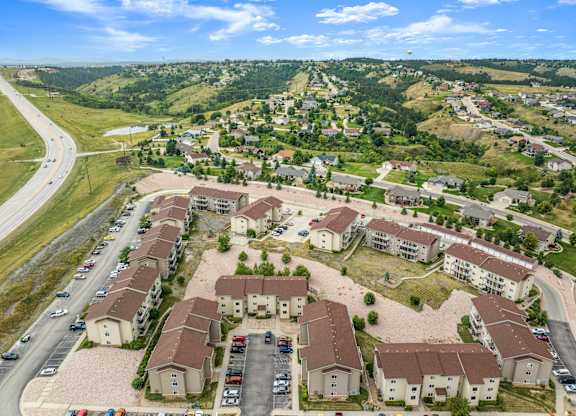A bird's eye view of a residential area with houses and cars.