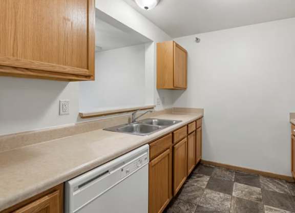 A kitchen with a washer and dryer built in to the cabinetry.