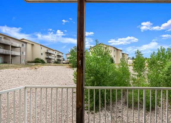 A view of apartment buildings through a fence.