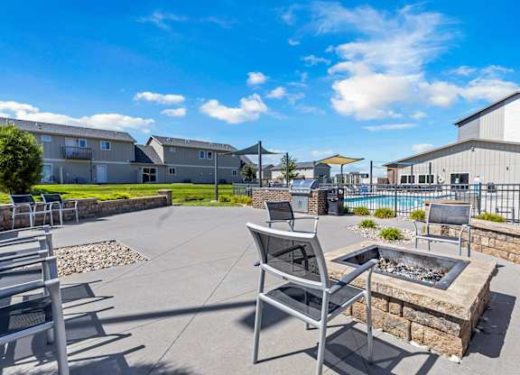 A patio area with a fire pit and seating area.