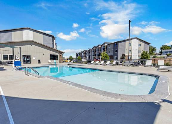 A swimming pool in a sunny outdoor setting.