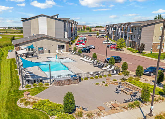 A large building with a pool in front of it.