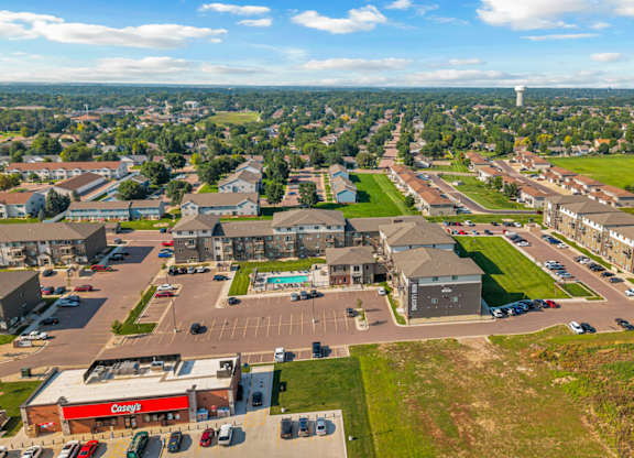 A view of a town from above with a large building in the foreground.