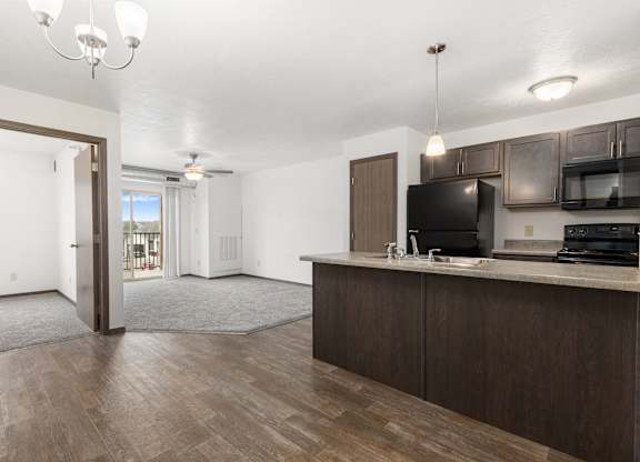 A kitchen area with a microwave, oven, and sink.