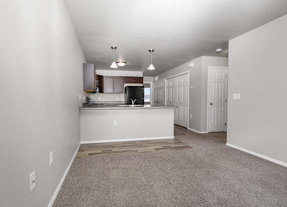 A spacious kitchen area with a countertop and cabinets.