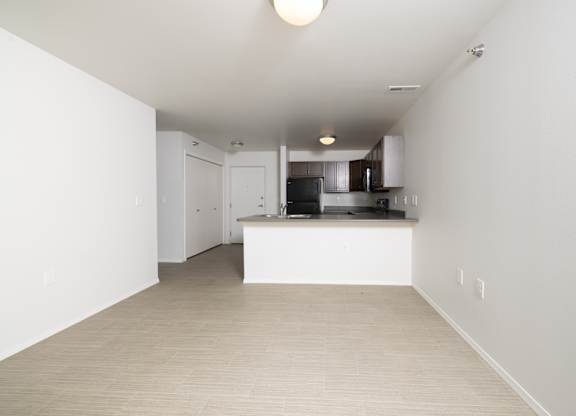 A kitchen area with a counter and cabinets.