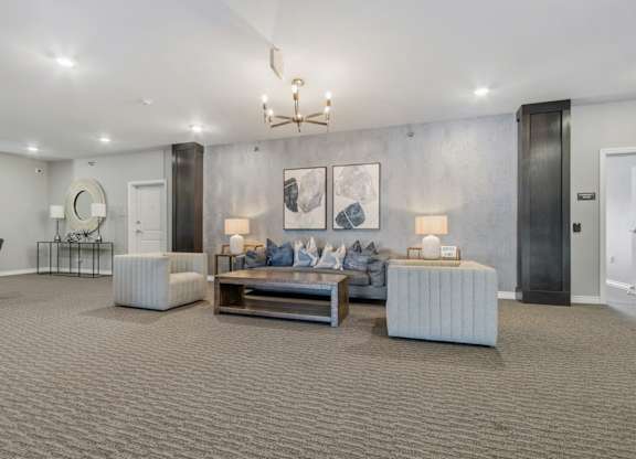 A modern living room with a grey carpet and furniture.