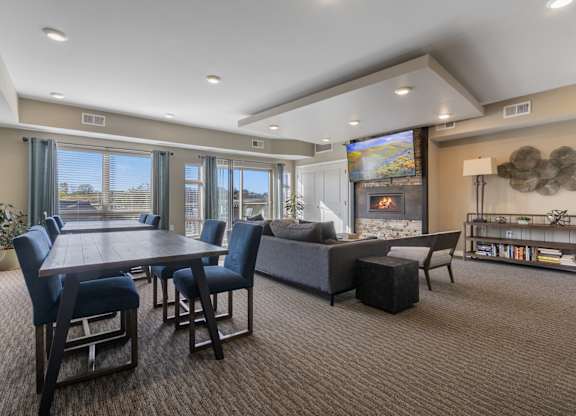 A modern living room with a dining table and chairs.