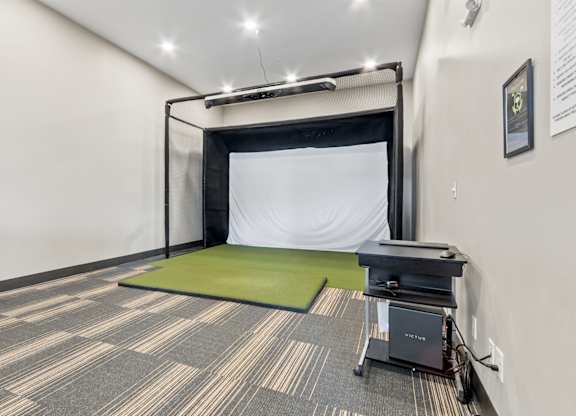 A room with a green mattress and a black table.
