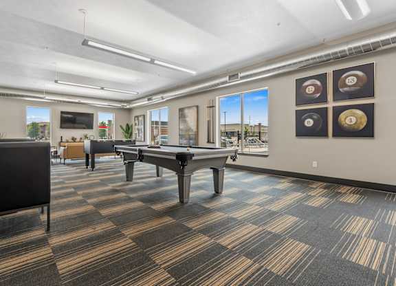 A room with a pool table and a foosball table.