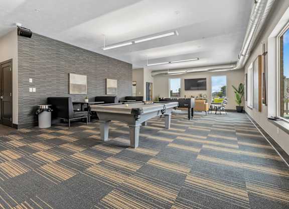 A conference room with a long table and chairs.