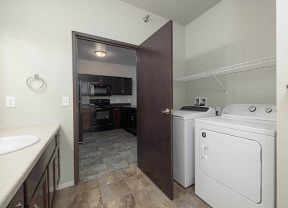 A small laundry room with a washer and dryer.