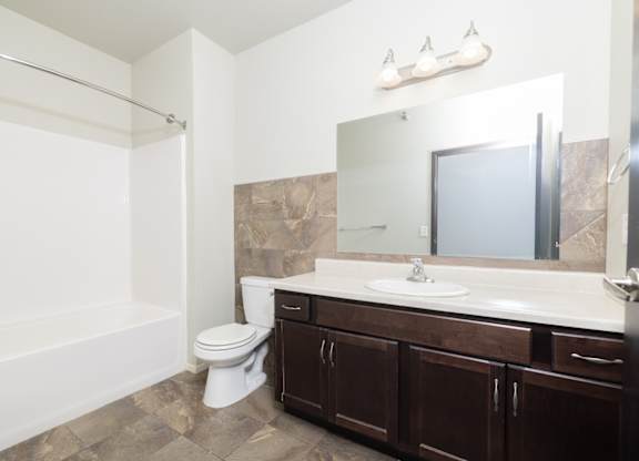 A bathroom with a white toilet and a white sink.