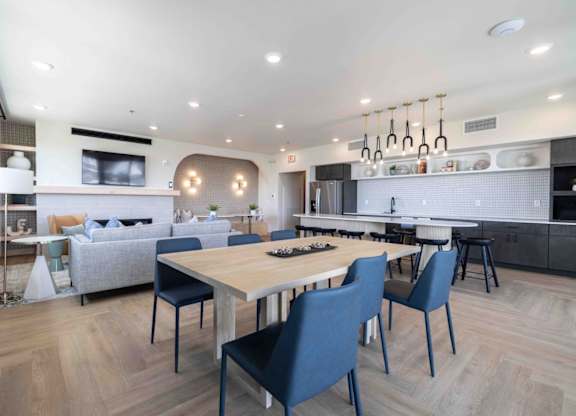 A modern kitchen with a dining table and chairs.