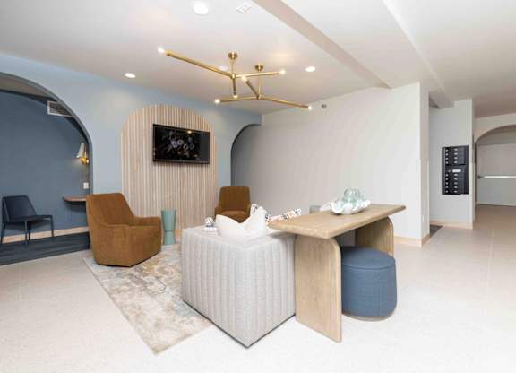 A modern living room with a white sofa and a wooden coffee table.