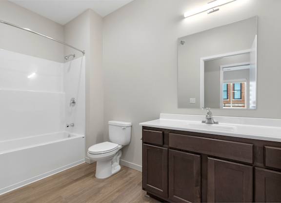 A white bathroom with a toilet, sink, and bathtub.