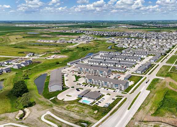 A bird's eye view of a residential area with houses and roads.