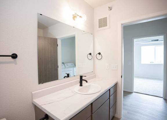 A bathroom with a sink and mirror.