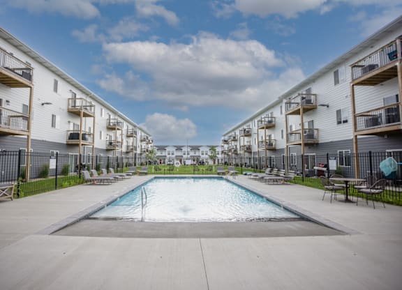 A swimming pool in the middle of apartment buildings.