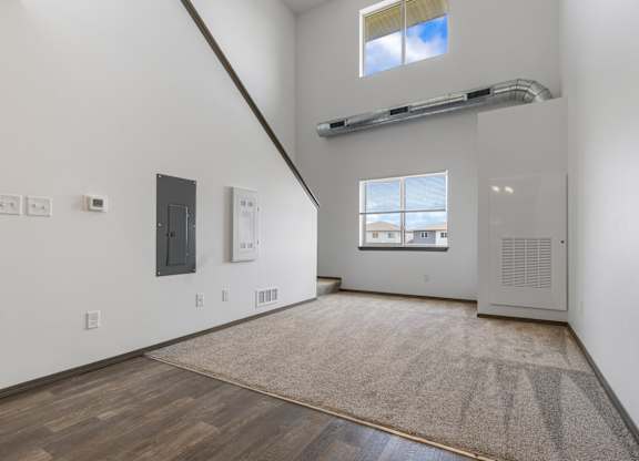 A room with a window and a door on the right side.
