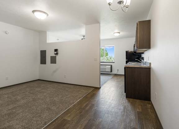 A room with a brown floor and white walls.