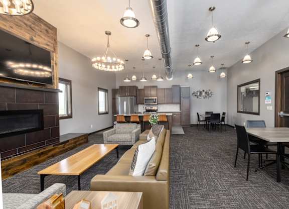 A modern living room with a fireplace and a dining area.