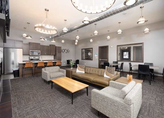 A modern office space with a kitchen area and seating arrangements.