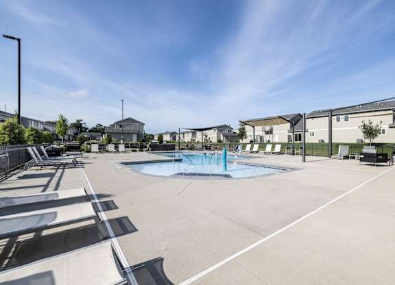A sunny day at the outdoor pool area of a residential complex.