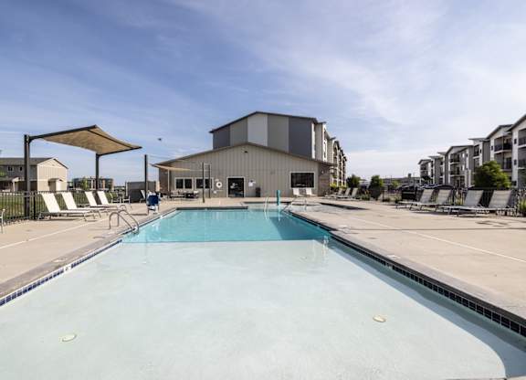 A large swimming pool in a sunny outdoor setting.