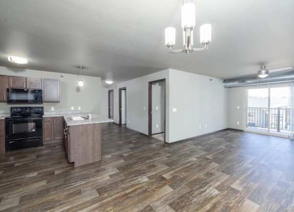 A living room with a kitchen area in the background.