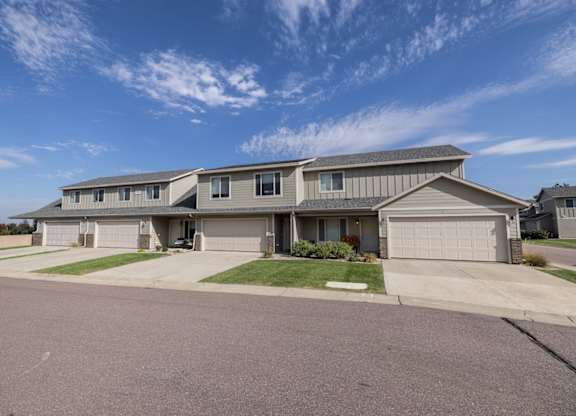 A large house with a garage is situated in a residential area.