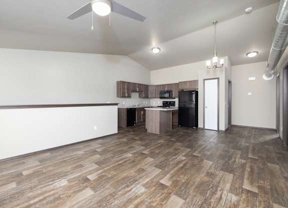 A room with a wooden floor and a ceiling fan.