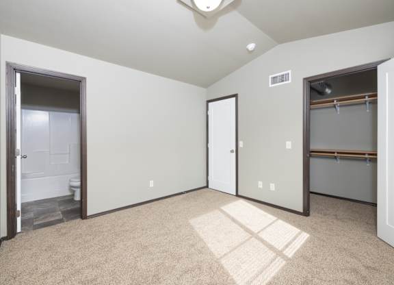 A room with a carpet on the floor and a window on the wall.