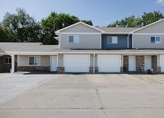A row of houses with garages in front.