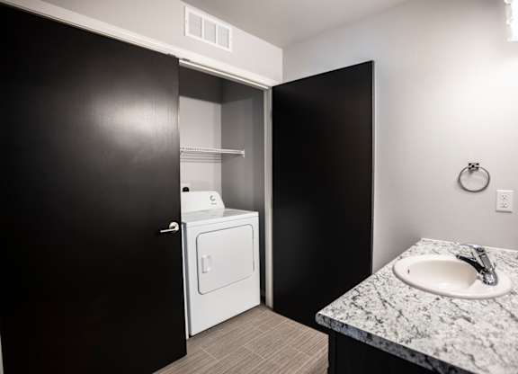 Laundry room with washer and dryer, and built-in cabinets.