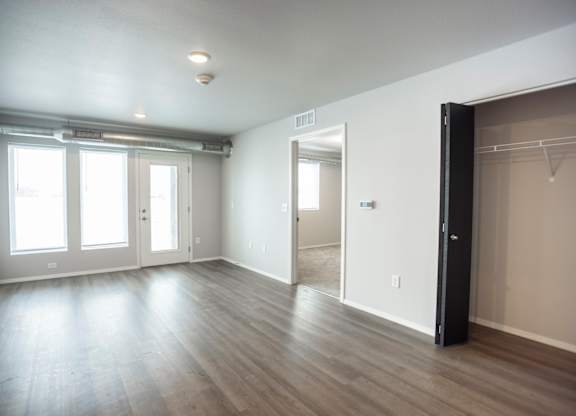Spacious living room with neutral walls and ample natural light.