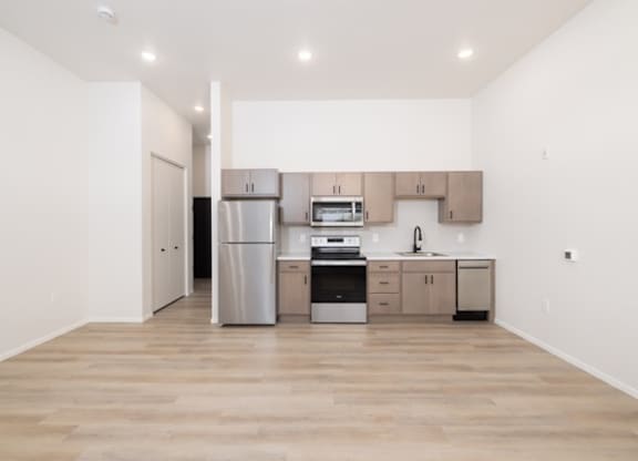 A kitchen with wooden floors and white walls.