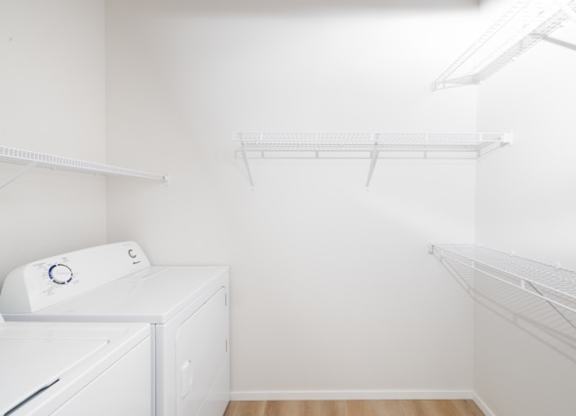 A white laundry room with a washer and dryer.