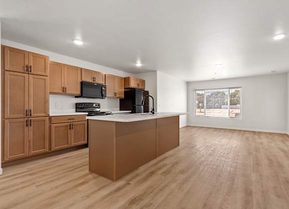 A kitchen with wooden cabinets and a white countertop.