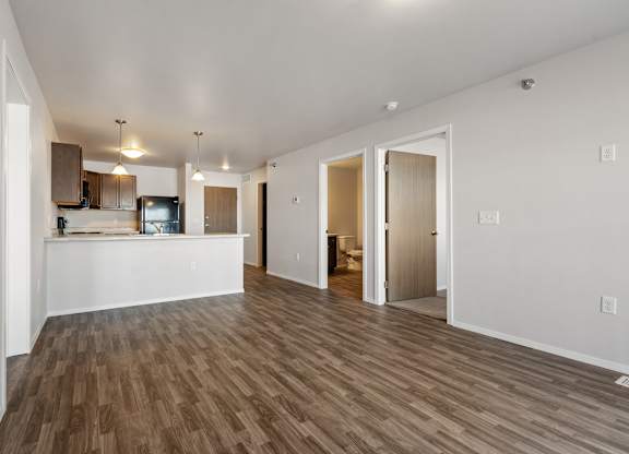 A room with a kitchen area and a living room area.