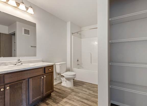 A bathroom with a toilet, sink, and bathtub.