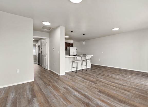 A room with a wooden floor and a white wall.