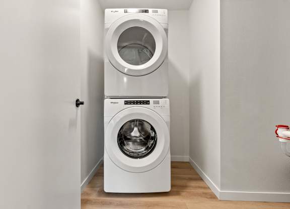 A white washing machine and dryer in a laundry room.