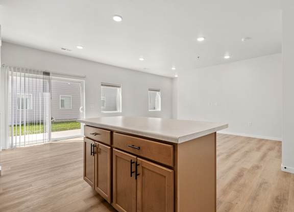 A kitchen with wooden cabinets and a white countertop.