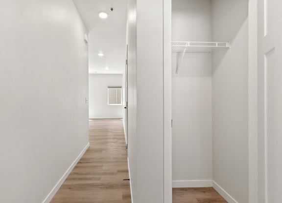 A white hallway with a door on the right.