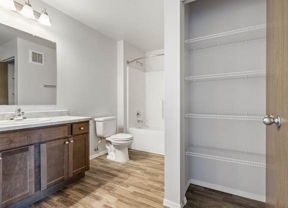 A bathroom with a toilet, sink, and a walk-in shower.
