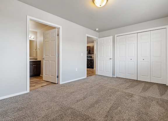 A room with a carpeted floor and white walls.